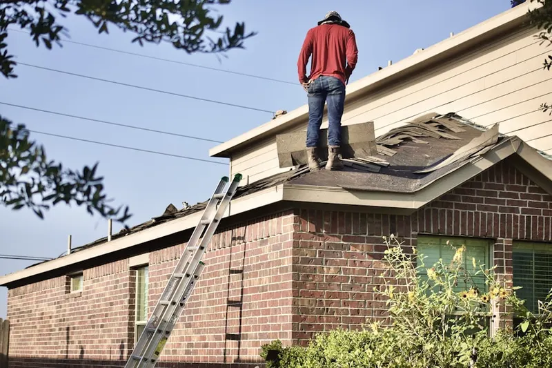 Professional roofer working on a residential roof in Villa Monterey